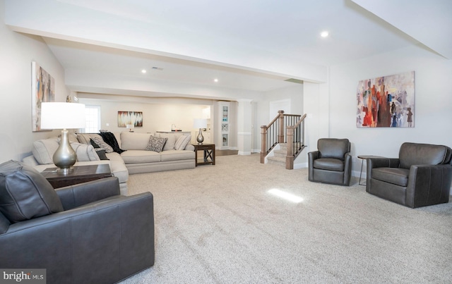 living room with carpet flooring, ornate columns, and beamed ceiling