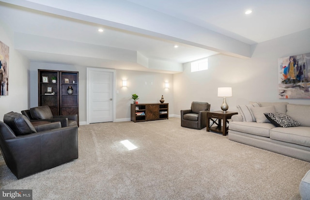 living room featuring beam ceiling and light colored carpet