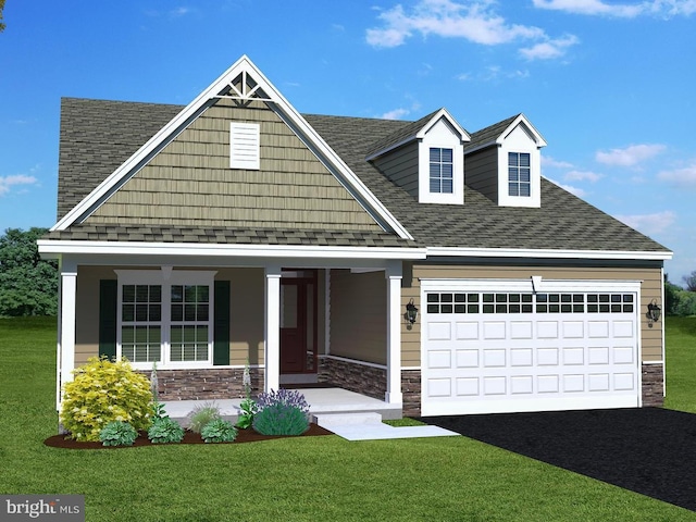 view of front facade with covered porch, a front yard, and a garage