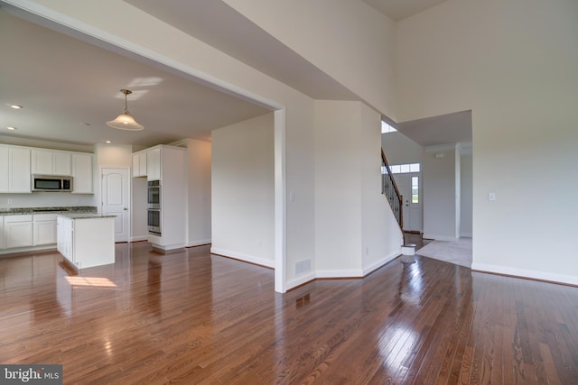 unfurnished living room featuring dark wood-type flooring