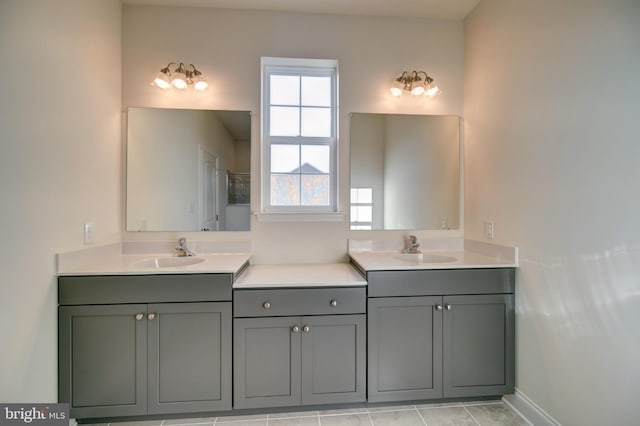 bathroom with tile flooring, double sink, and large vanity