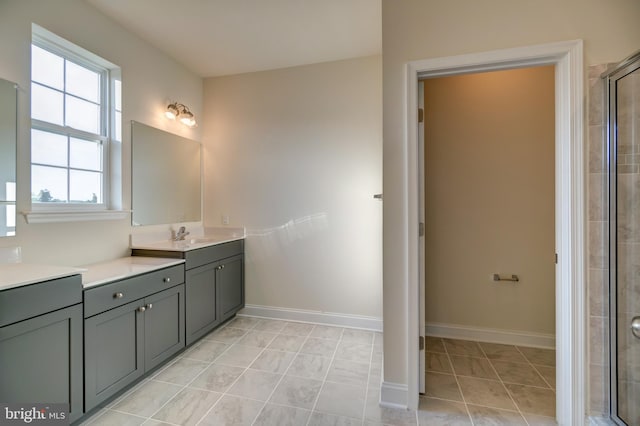 bathroom featuring tile floors, a shower with shower door, and vanity