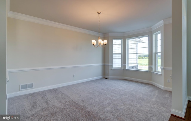 empty room featuring crown molding, carpet flooring, and a chandelier