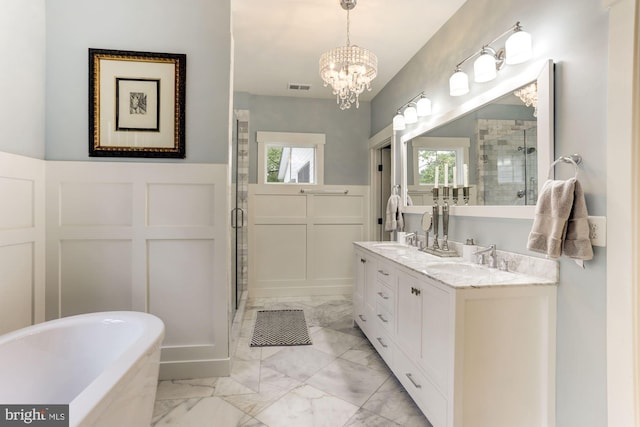 bathroom with a chandelier, vanity, and independent shower and bath