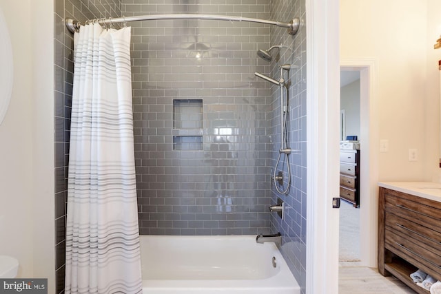 bathroom featuring shower / bath combination with curtain, wood-type flooring, and vanity