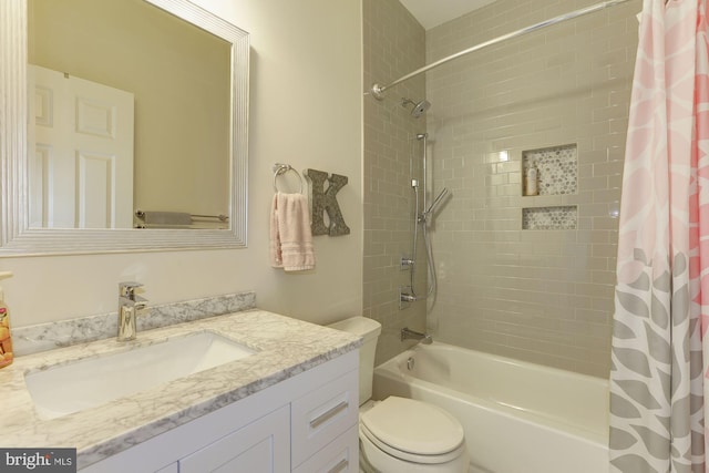 full bathroom featuring shower / bath combination with curtain, toilet, and vanity