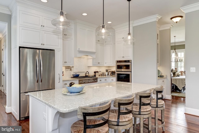 kitchen featuring dark hardwood / wood-style floors, light stone counters, white cabinetry, and stainless steel appliances