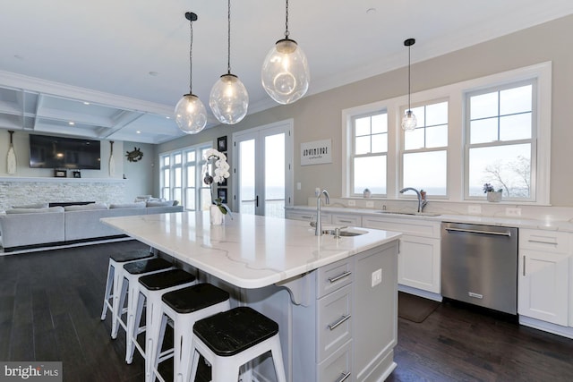 kitchen featuring dishwasher, a center island with sink, white cabinetry, and sink