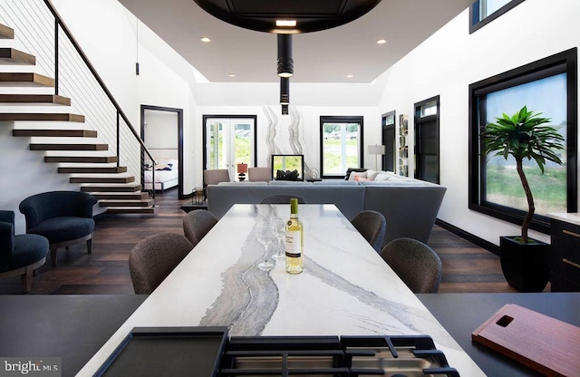 dining room with a high ceiling and dark wood-type flooring