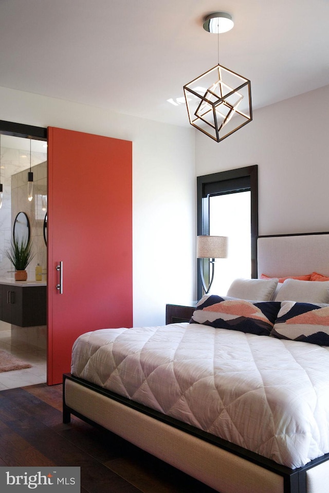 bedroom with a notable chandelier and dark hardwood / wood-style floors