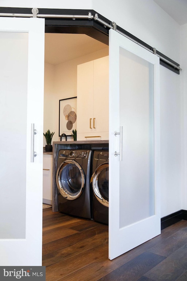 washroom featuring a barn door, cabinets, and dark hardwood / wood-style flooring