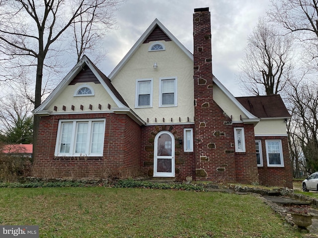 english style home with a front yard