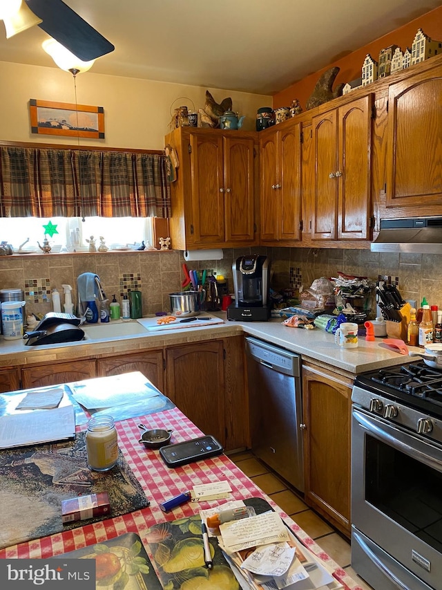 1457 W Landis Ave, Vineland, NJ 08360 - kitchen featuring light tile patterned flooring, stainless steel appliances, tasteful backsplash, and exhaust hood