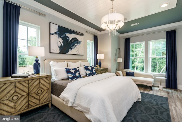 bedroom with an inviting chandelier, crown molding, and dark hardwood / wood-style floors