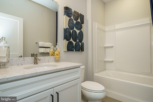 full bathroom with toilet, vanity with extensive cabinet space, and bathing tub / shower combination