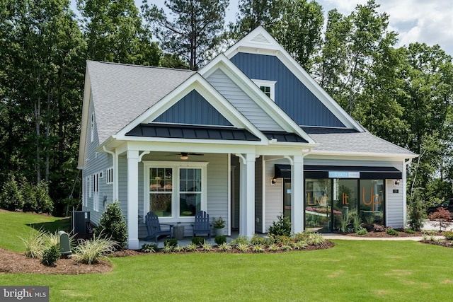 view of front of home featuring a front yard, ceiling fan, and a porch