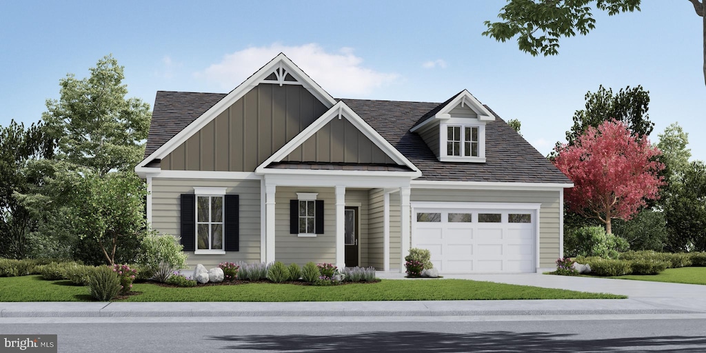 view of front of property with a front yard and a garage