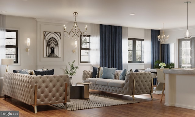 living room featuring a healthy amount of sunlight, a notable chandelier, and wood-type flooring