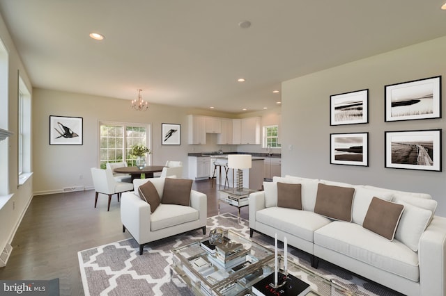 living room featuring light hardwood / wood-style floors and a notable chandelier