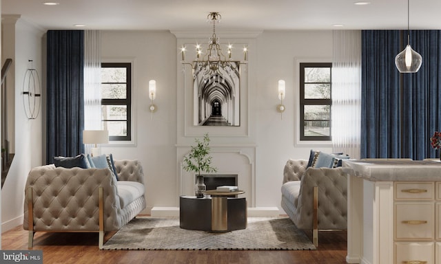 living area featuring a wealth of natural light, ornamental molding, a chandelier, and hardwood / wood-style flooring