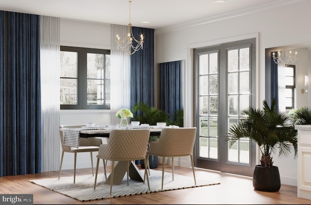 dining room featuring light hardwood / wood-style flooring, ornamental molding, and an inviting chandelier