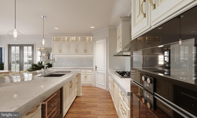 kitchen with backsplash, dark stone counters, sink, decorative light fixtures, and stainless steel gas stovetop