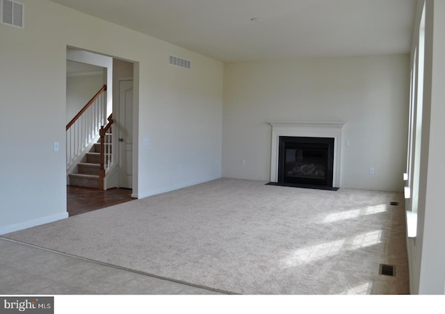 unfurnished living room with dark carpet