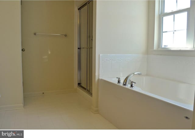 bathroom with separate shower and tub and tile floors