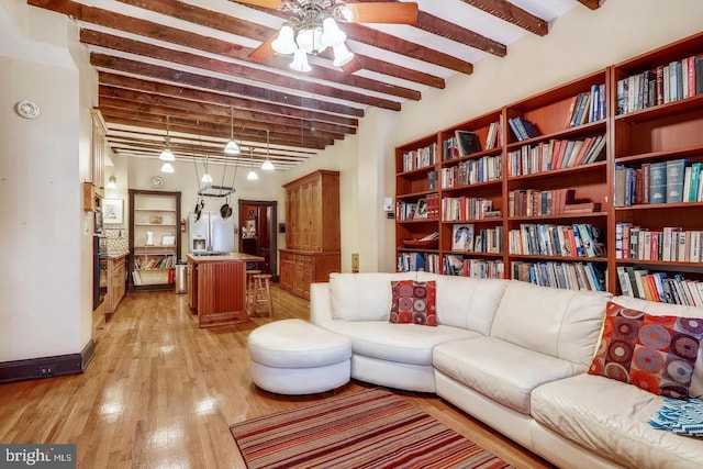 living room featuring ceiling fan, beamed ceiling, and light hardwood / wood-style floors