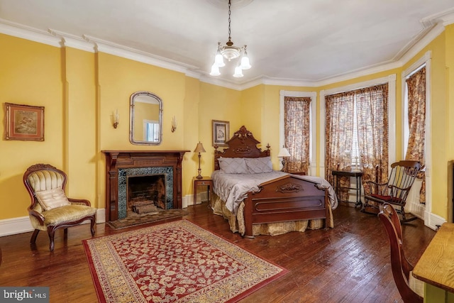 bedroom with an inviting chandelier, ornamental molding, and dark wood-type flooring