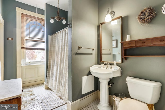 bathroom featuring toilet and tile floors