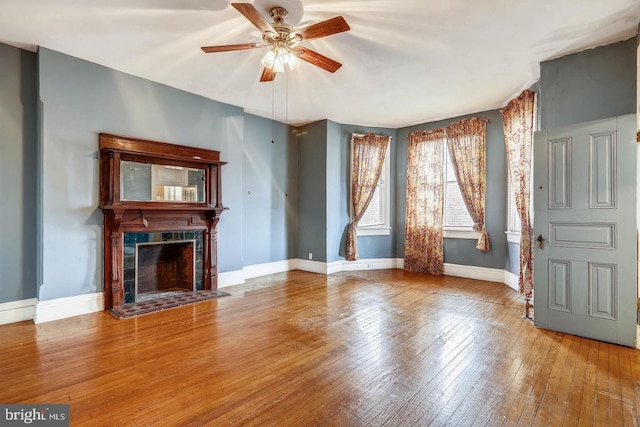 unfurnished living room with ceiling fan and light wood-type flooring