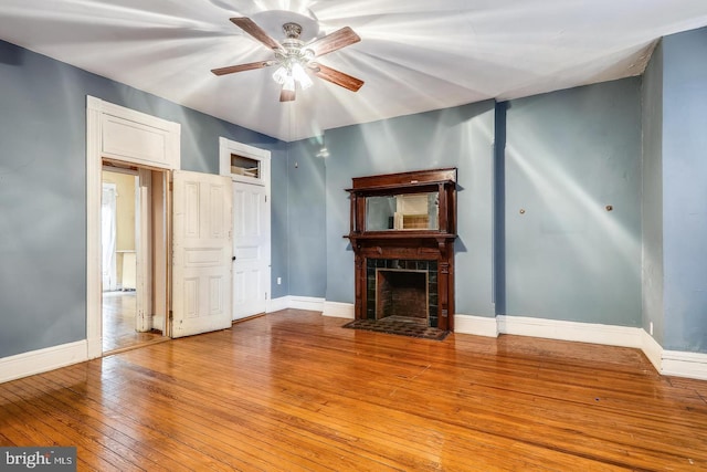 unfurnished living room with ceiling fan and light wood-type flooring