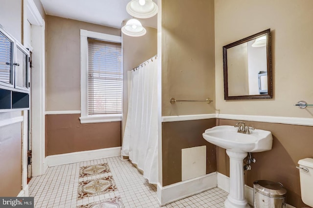 bathroom with tile floors and toilet