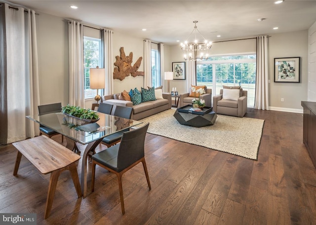 dining space with dark hardwood / wood-style flooring, a chandelier, and a healthy amount of sunlight