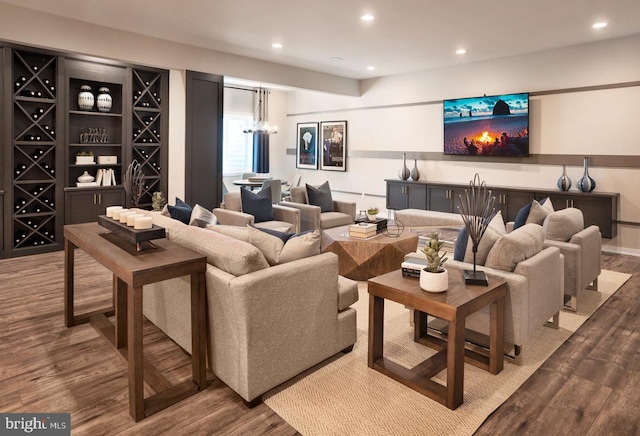 home theater room featuring hardwood / wood-style flooring and a chandelier