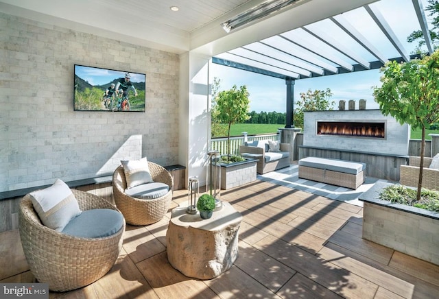 exterior space with an outdoor living space with a fireplace and a pergola