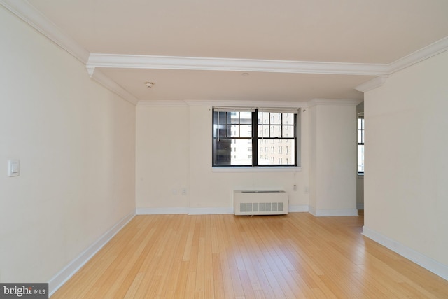 unfurnished room with radiator heating unit, ornamental molding, and light wood-type flooring