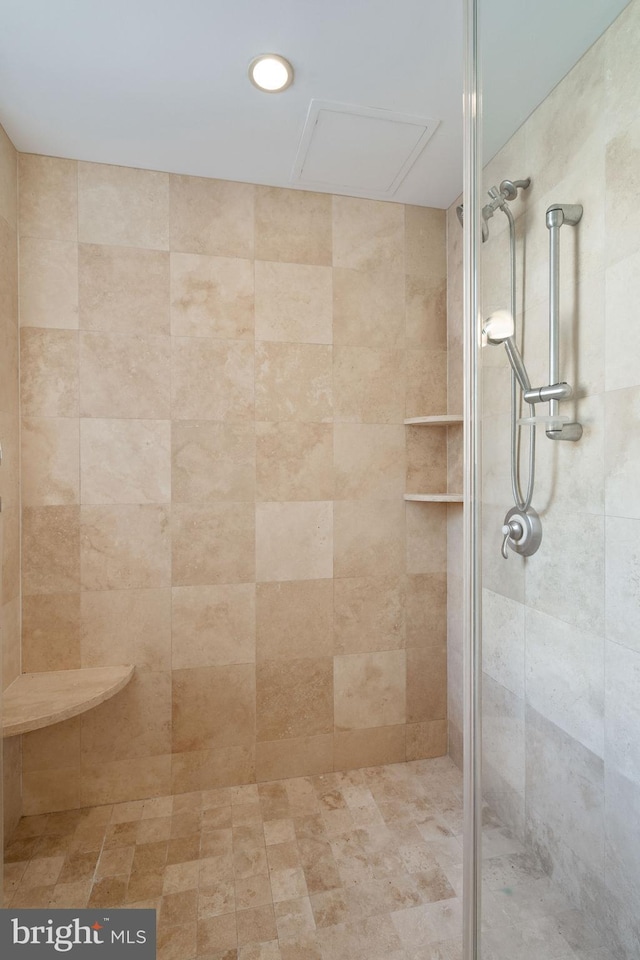 bathroom with tiled shower