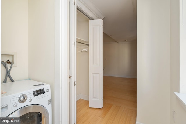 laundry room featuring light hardwood / wood-style floors and washer / dryer