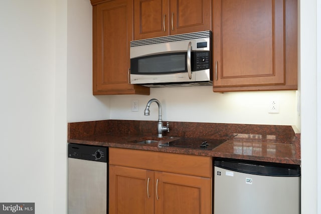 kitchen featuring dark stone countertops and appliances with stainless steel finishes