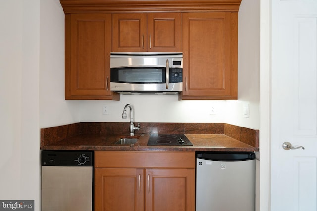 kitchen featuring dark stone countertops and stainless steel appliances