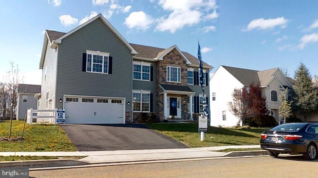 view of front of house with a front lawn and a garage