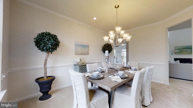 carpeted dining area featuring a chandelier and crown molding