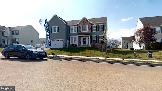 view of front of home featuring a front yard and a garage