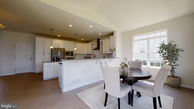 dining space featuring light hardwood / wood-style floors