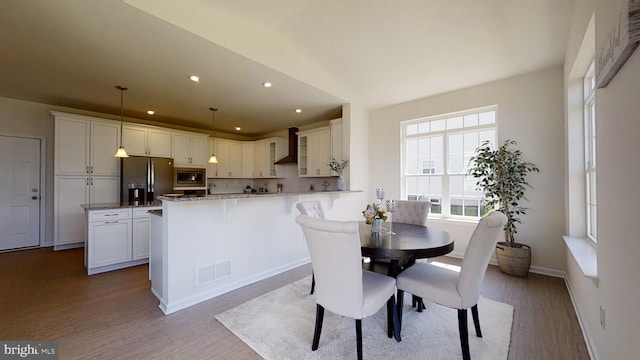 dining area with light hardwood / wood-style flooring