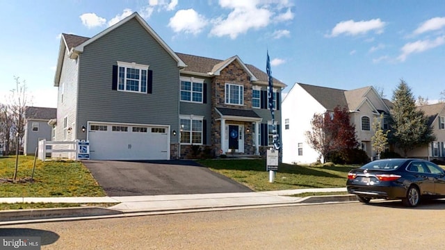 view of front of property featuring a front yard and a garage