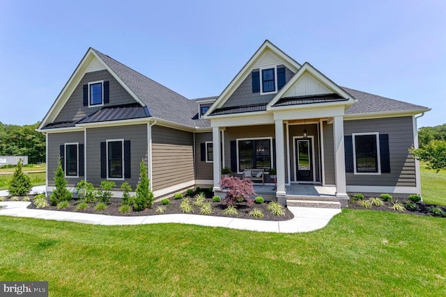 craftsman-style home featuring a front yard and covered porch