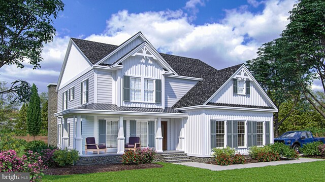 view of front of property with a porch and a front lawn